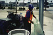 Custodian maintains sidewalks near the L.A. Convention Center with a small riding street sweeper